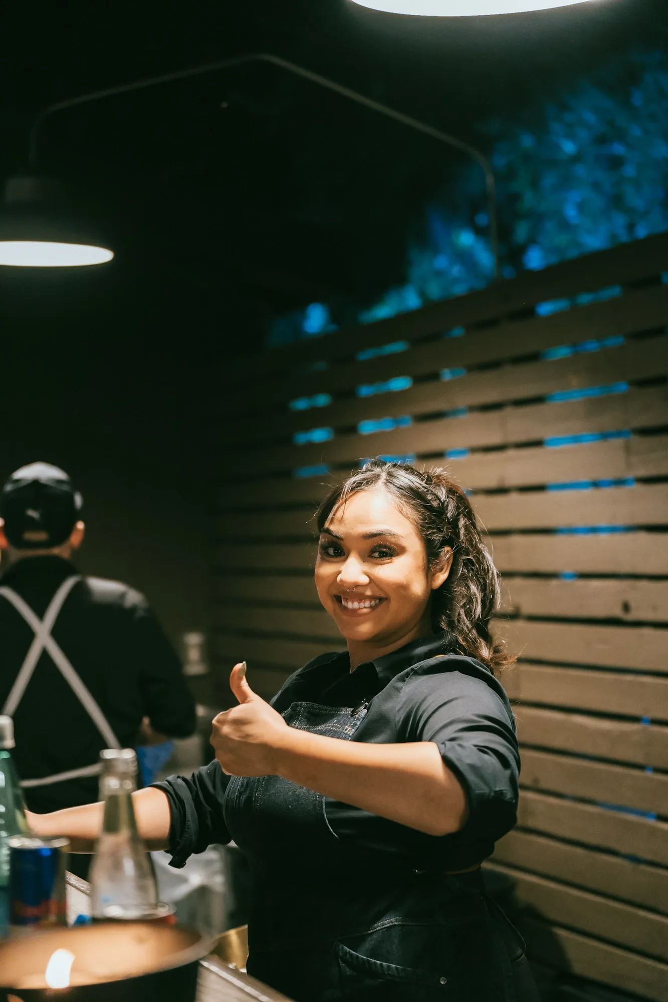 Bartender serving guests at an evening event.