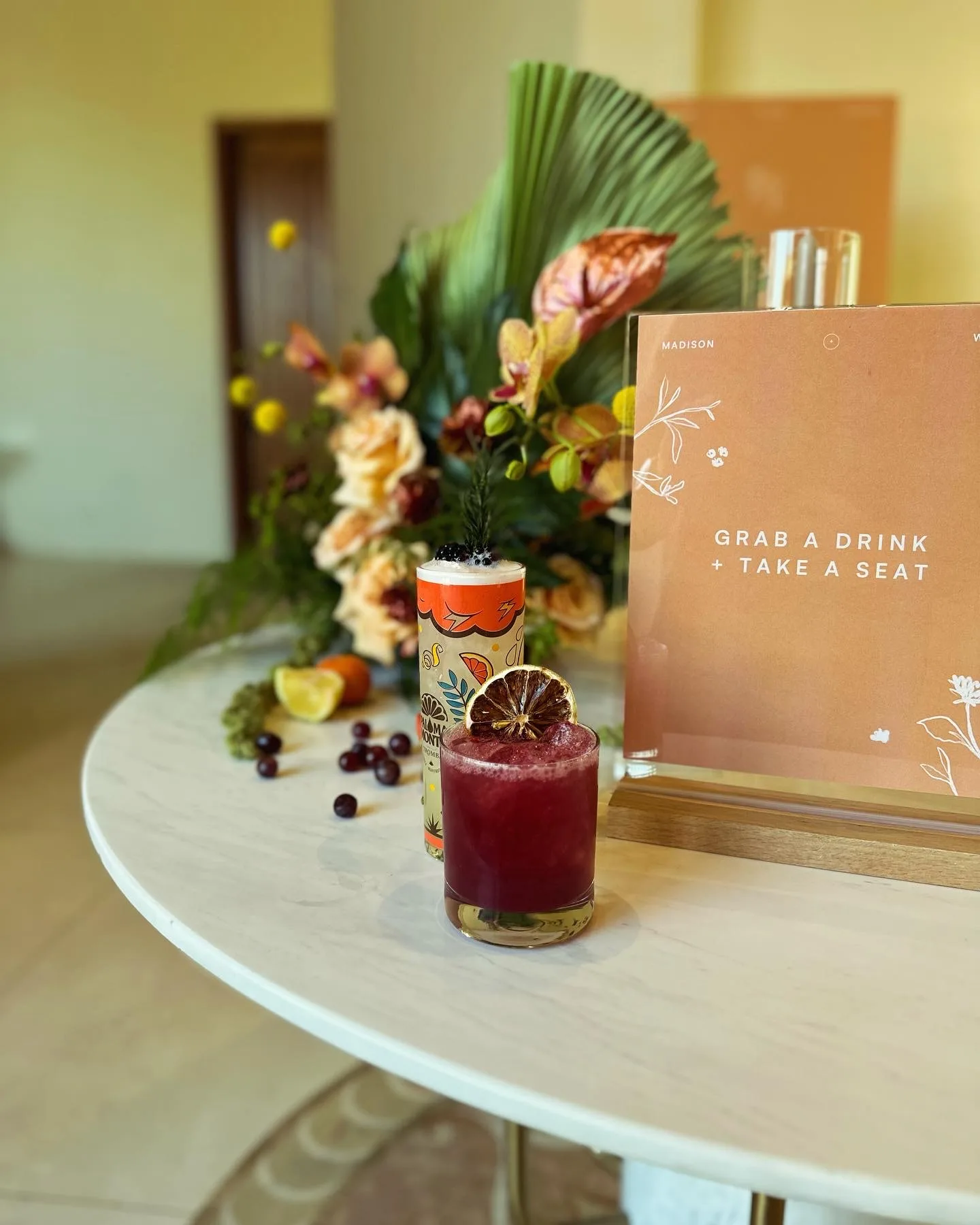 A custom cocktail styled with flowers and event stationery.