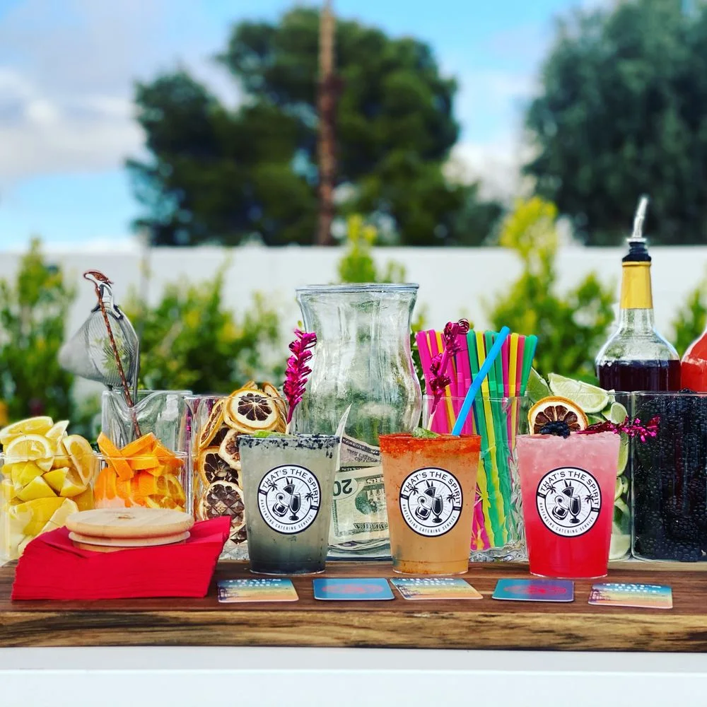 Colorful outdoor mobile bar arranged with cocktails, fruit, and bright straws