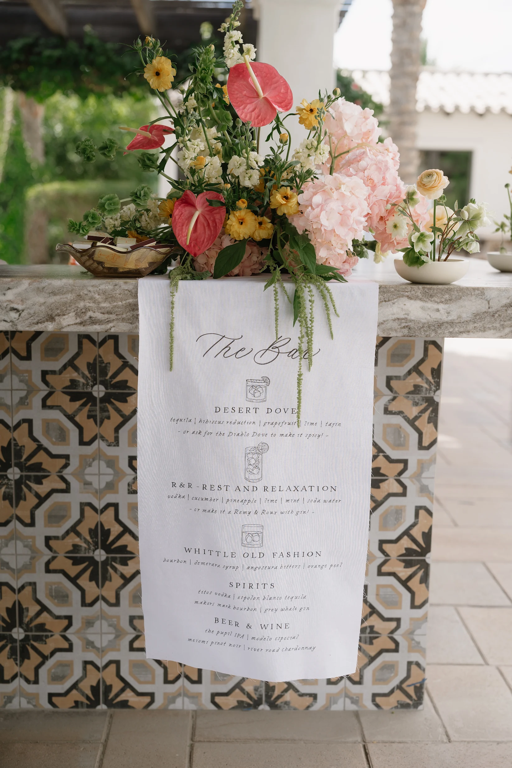 A personalized wedding cocktail menu on the reception bar.