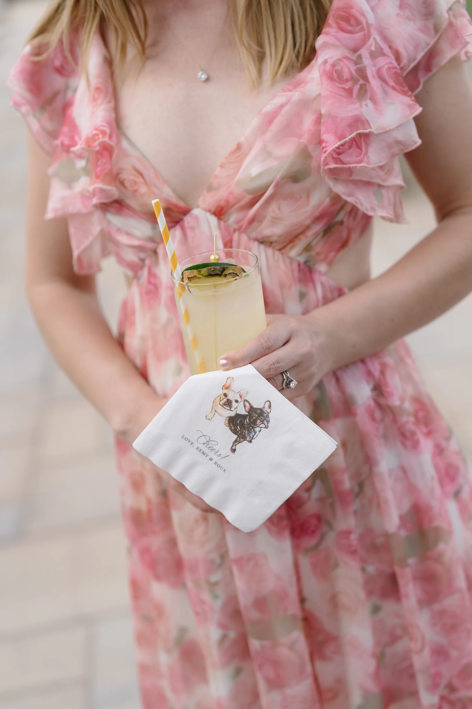 A pale wedding cocktail with a personalized napkin.