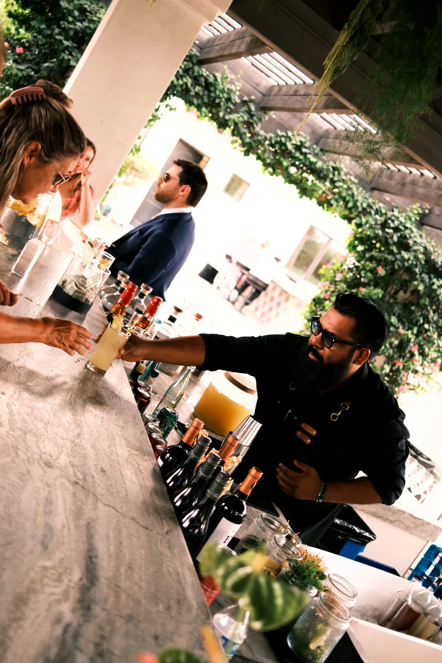 Bartenders preparing drinks behind the wedding bar.
