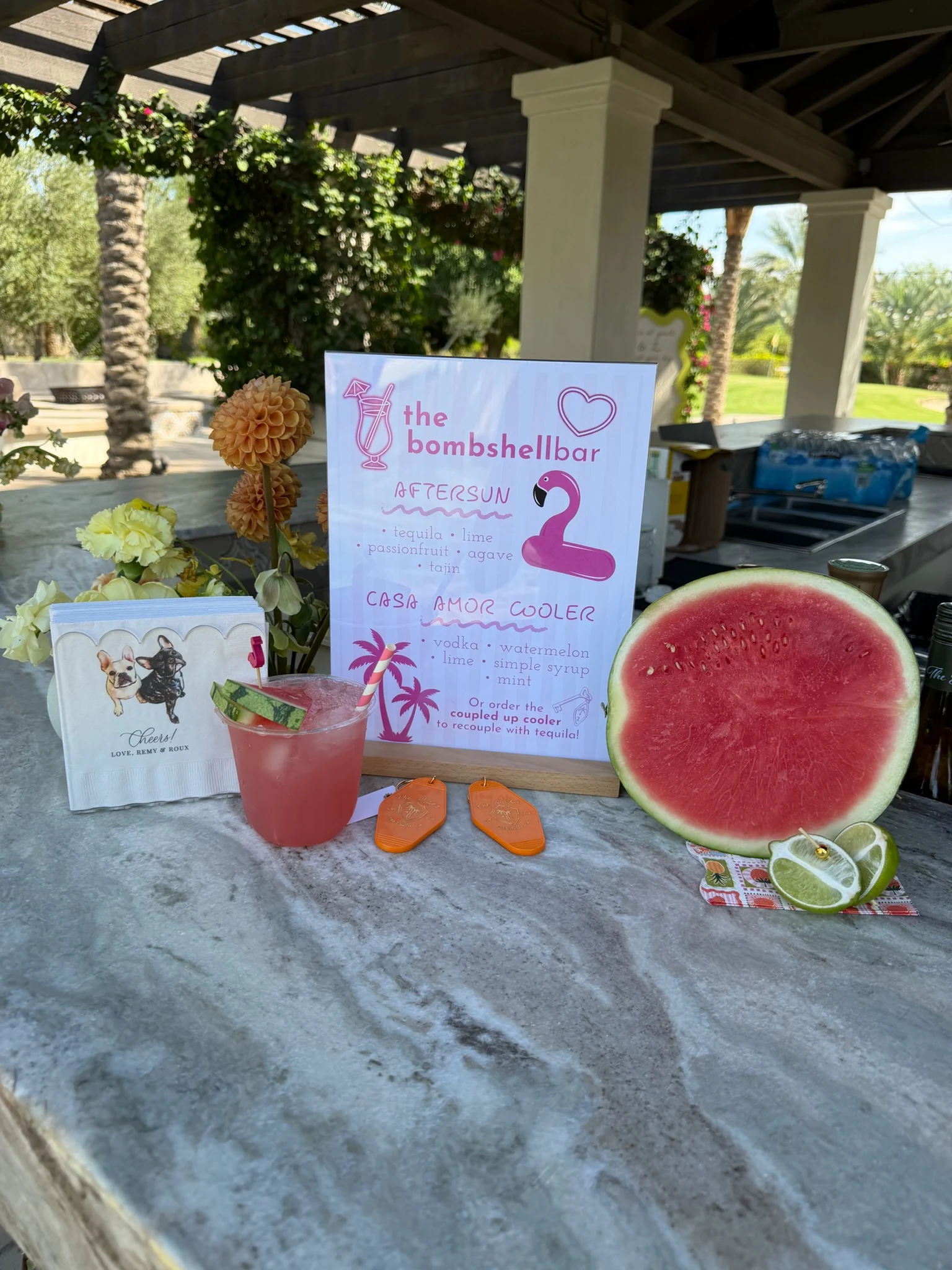 A watermelon-themed cocktail station and menu sign.