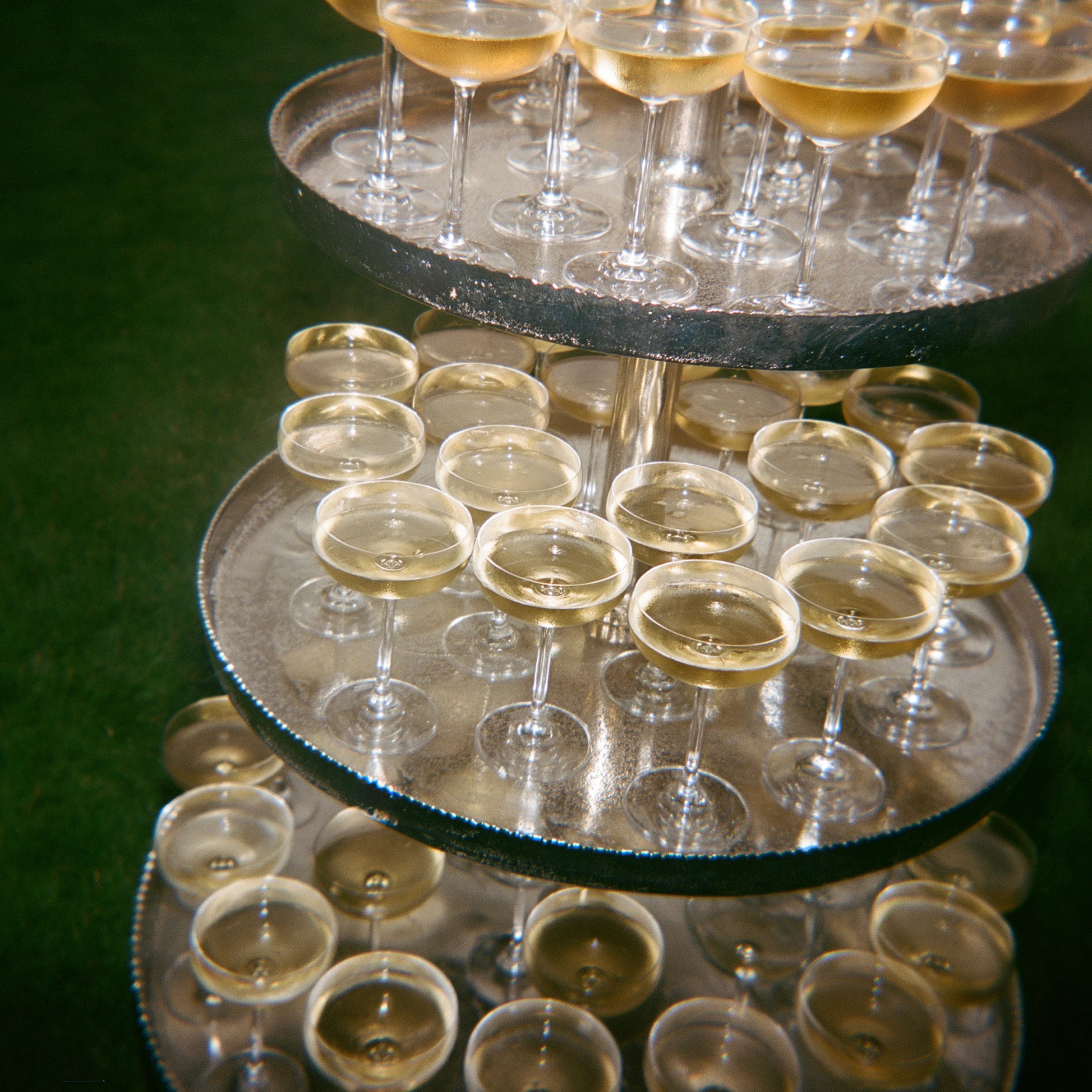 A champagne tower filled for a wedding toast.