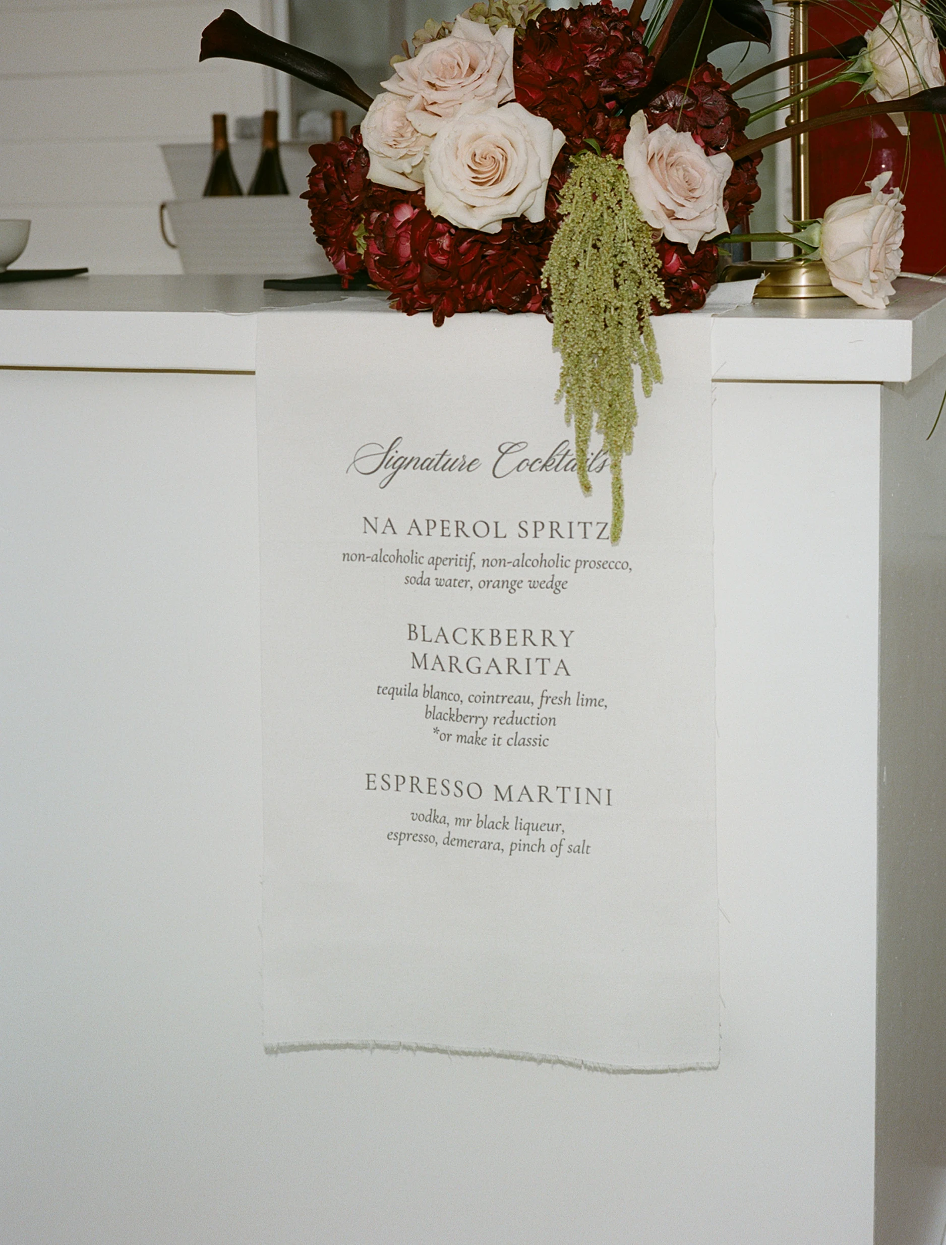A wedding signature cocktail menu with floral detail.