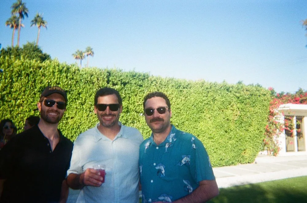 Three guests enjoying drinks outdoors in Palm Springs.
